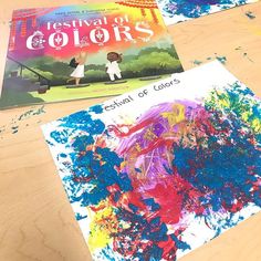 two children's books sitting on top of a wooden table next to each other