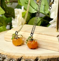 Such darling, dainty, little pumpkins!  These little pumpkins are orange agate so each one is a little bit different but will be relatively the same shade as the photos.  These tiny pumpkins are adorned by bronze metal findings, all nickel free, with gold artistic wire used for the vines. Wire is gold plated, nickel free, and tarnish resistant. Gold vines are handmade by me so each one will look a bit different :)  Pumpkin pendant is approx 0.7" so it is quite dainty. perfect for everyday wear t Orange Necklace For Halloween Gift, Cute Nickel-free Orange Jewelry, Cute Handmade Orange Jewelry, Cute Orange Handmade Jewelry, Handmade Jewelry For Fall Gift, Stone Pumpkin, Tiny Pumpkins, Heart Enamel Pin, Light Up Pumpkins