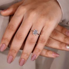 a woman's hand with a diamond ring on it