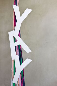 a piece of paper that has been cut out into letters and lines on the wall