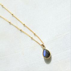 "This charm necklace is a great way to add a little color to your everyday. Simple, classic and versatile this drop necklace comes in your choice of chain style and stone. D E T A I L S - Created with a dainty gold plated gem drop approx 10mm by 7mm. - Your choice of high quality 14kt gold filled link or satellite chain. Choose between: 1. smoky quartz 2. rose quartz 3. emerald 4. howlite turquoise 5. moonstone 6. labradorite 7. clear quartz L E N G T H - Please select from the drop down selecti Dainty Everyday Necklaces With Natural Stones, Dainty Teardrop Pendant Necklace With Natural Stones, Elegant Labradorite Necklaces With Birthstone, Dainty Labradorite Jewelry For Everyday, Elegant Labradorite Necklace With Adjustable Chain, Dainty Labradorite Pendant Necklace, Elegant Labradorite Necklace For Gift, Elegant Labradorite Necklace Gift, Delicate Gold Necklace