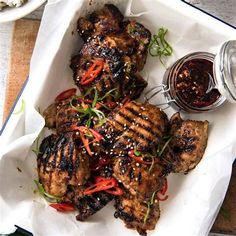 grilled meat with vegetables and sauce on a tray