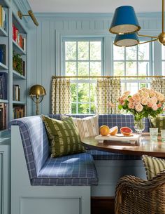 a table and chairs in a room with blue walls