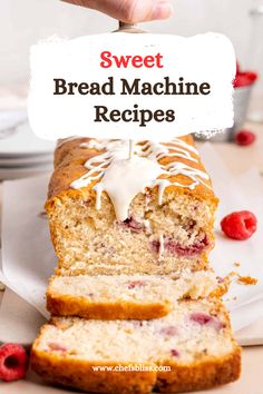 a loaf of bread with white icing and raspberries on top, sitting on a plate