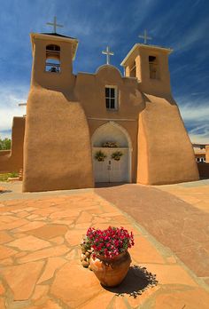 a small potted plant sitting in front of a church