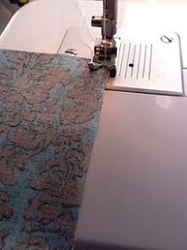 the sewing machine is next to the fabric on the table top, which has been sewn