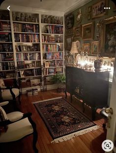 a living room filled with lots of furniture and bookshelves next to a doorway