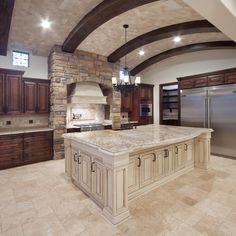 a large kitchen with an island in the middle and lots of cabinets on both sides