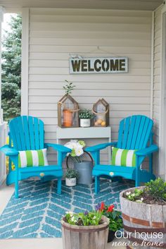 two blue adiron chairs sitting on top of a porch next to a potted plant