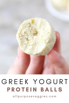 a hand holding up a greek yogurt protein ball in front of the camera