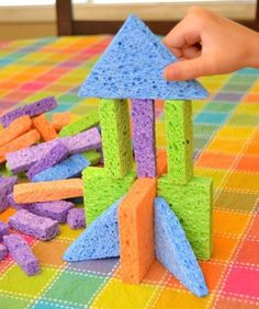 someone is playing with colored blocks on the table