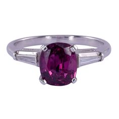 Estate 1.59 carat ruby platinum ring. This estate ring is crafted in platinum and features a 1.59 carat ruby center with two tapered baguette diamond accents. The diamonds have .12 carat total weight with VS clarity and F-G color. This ruby ring is a size 6.25. [KIMH 2934 P] *Resizing available for additional charge. Gia Certified Baguette Cut Ruby Ring, Classic Baguette-cut Ruby Ring, Classic Red Diamond Ring, Baguette Cut, Classic Red Baguette-cut Diamond Ring, Classic Red Baguette Cut Diamond Ring, Solvang Ca, Estate Ring, Resize Ring, Silver Gift Wrap