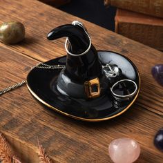 a black and gold harry potter hat on a wooden table next to some crystal balls