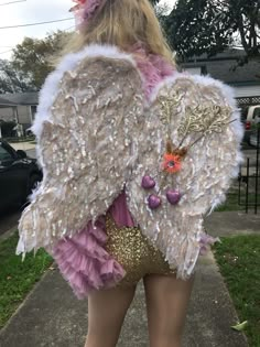 the back of a woman's body wearing an angel costume