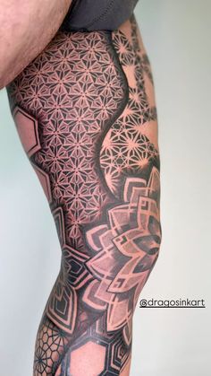 a man's leg with tattoos on it and an intricate design in the middle