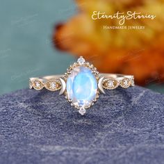 Moon Stone Wedding Ring, Celestial Opal Birthstone Ring In Oval Shape, Celestial Oval Opal Birthstone Ring, Moon Shaped Rose Cut Diamond Jewelry Gift, Celestial Rose Cut Diamond Wedding Jewelry, Celestial Style Rose Cut Diamond Wedding Jewelry, Celestial Moonstone Halo Ring For Wedding, Elegant Moon Shaped Gemstone Rings, Celestial Halo Moonstone Wedding Ring