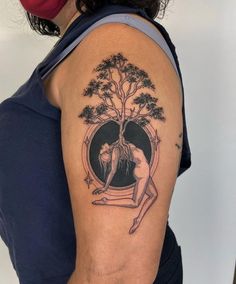 a woman with a tree tattoo on her arm