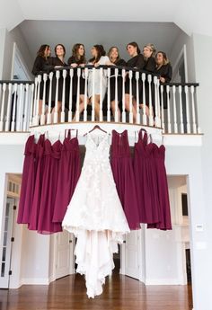 the bride and her bridesmaids are hanging out on the balcony