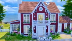 a red and white house sitting on top of a lush green field