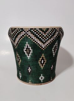 a green and white basket sitting on top of a table