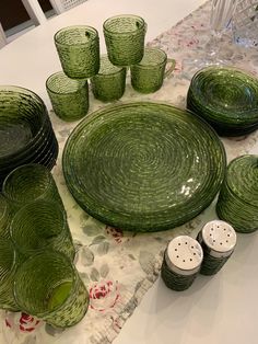 green glass dishes and cups on a table