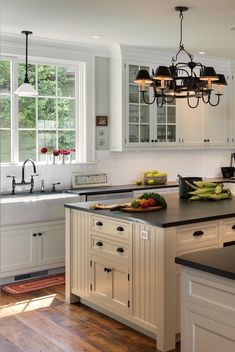 a large kitchen with an island in the middle and lots of counter space around it