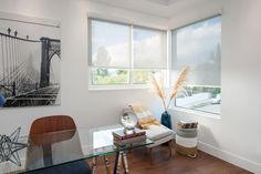 a living room with a glass table and chairs