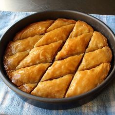 a pan filled with pastry sitting on top of a blue towel