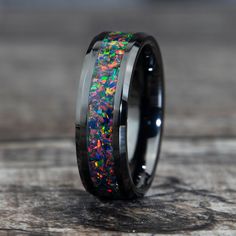 "This Black Fire Opal Ring made in a black ceramic band has beautiful flashes of color when the light hits it.  Why buy from us? We do our best to make the ring buying process simple and easy for you. With this ring we include: ** Made With Love ** ** Easy Size Exchange ** ** FREE 1 Year Limited Warranty ** ** A portion of the sale goes to support charity ** Buy with confidence knowing we will do everything we can to make sure you're happy with the purchase :) || Features || - Black ceramic band Black Titanium Round Jewelry, Black Titanium Jewelry Gift, Black Titanium Jewelry As Gift, Opal Ring For Men, Fire Opal Jewelry, Black Fire Opal, Engagement Ring For Him, Cool Rings For Men, Opal Wedding Band