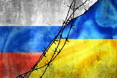 barbed wire on top of a flag with the colors of ukraine and red, white, blue, and yellow