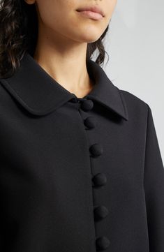 Voluminous sleeves frame a lightweight knit jacket ornamented with fabric-covered buttons and finished with a tie at the waist. Front button-and-loop closure Peter Pan collar Bracelet-length sleeves Attached waist tie Lined 92% polyester, 8% elastane Dry clean Imported Elegant Lapel Collar Cardigan For Work, Elegant Cardigan With Lapel Collar For Workwear, Elegant Formal Cardigan With Lapel Collar, Elegant Tailored Cardigan With Lapel Collar, Elegant Workwear Cardigan With Hidden Button Closure, Chic Outerwear With Lapel Collar And Covered Buttons, Chic Outerwear With Covered Buttons And Lapel Collar, Elegant Single Breasted Cardigan With Lapel Collar, Elegant Winter Cardigan With Hidden Button Closure