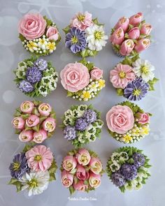 a bunch of flowers that are sitting on a table with white and pink flowers in them