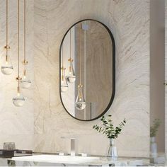 an elegant bathroom with marble counter tops and gold fixtures, along with hanging lights on the wall