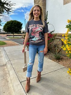 Our Wild West Cowgirls Graphic Top is perfect for your inner cowgirl! This western graphic t-shirt features sassy cowgirl boots and cowgirl hat, sure to give you the western flair you've been dreaming of! Yee-haw! Color: Dark Gray Fabric: 100% Cotton Made: El Salvador Includes: x1 T-Shirt Sizes: S-XL, Regular Sizing Casual T-shirt For Western-themed Fall Events, Western Style T-shirt For Fall Western-themed Events, Western-style T-shirt For Western-themed Fall Events, Country Style T-shirt For Rodeo In Fall, Western Style T-shirt For Rodeo, Fall Graphic Print T-shirt For Country Events, Western Style T-shirt For Spring Ranch, Yee Haw, Graphic Top