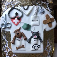 a cake decorated to look like a veterinarian's house with dogs and cats on it