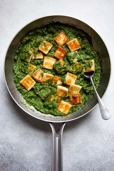 a pan filled with spinach and tofu