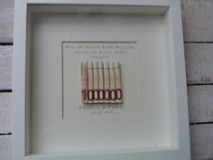 a white frame with four different colored toothbrushes in it