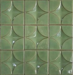 a green tile wall with circles on it