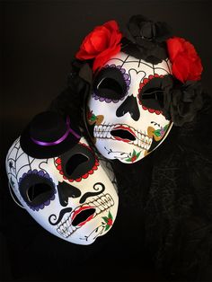 The men's mask features a striking sugar skull design, paying homage to the Day of the Dead tradition. Meanwhile, the women's mask is adorned with flowers, adding a touch of timeless elegance. These masks are the ideal companions for masquerade balls, themed parties, or any event where you want to express your love for tradition and style.


Age Group/Gender - Adult/Unisex

Size/Type - One size fits all adults

Mask Color - Red/Purple

Mask Material - Polyresin

Accent Material - Paint Sugar Skull Masks, Day Of The Dead Masks, Purple Masquerade, Skull Masks, Day Of The Dead Mask, Couples Masquerade Masks, Purple Mask, Sugar Skull Design, Female Mask