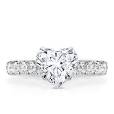 a heart shaped diamond ring with white diamonds