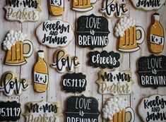 decorated cookies are arranged in the shape of beer bottles and mugs with words on them