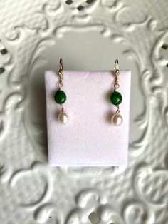 These Akoyas pearls are from the estate of a jeweler in Connecticut that I picked up last year on my New England buy.  These are from the 1980's according to the label on the sleeve. Gorgeous creamy white iridescent nacre. The 10mm Brazilian emeralds are new. 14k gold filled filled beads, on 14k gold filled ear wires earrings Stamped are made in the USA. Elegant Green Briolette Jewelry, Classic Green Drop Earrings, Classic Handmade Pear-shaped Jewelry, Classic Green Pearl Drop Jewelry, Green Round Classic Pearl Earrings, Green Pearl Drop Jewelry For Gifts, Green Pearl Drop Jewelry As Gift, Green Dangle Pearl Earrings For Anniversary, Green Pearl Drop Earrings For Anniversary