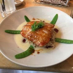 a white plate topped with meat and veggies