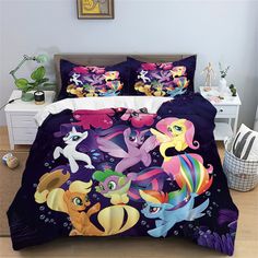 a bed with many different colored ponys on the cover and pillow cases in front of it