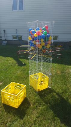 two yellow crates with balls in them on the grass