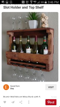 a wooden wine rack holding several bottles and glasses