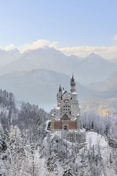 a castle on top of a mountain covered in snow