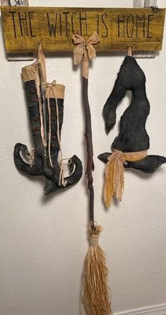 the witch's home is decorated with brooms, boots and witches hat hanging on a wall