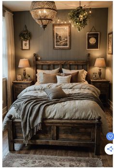 a large bed sitting in a bedroom next to two lamps and pictures on the wall