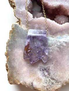 Beautiful raw amethyst slice necklace. This amethyst necklace is perfect for anyone who loves this purple gemstone or who has a February Birthday. Handcrafted Raw Amethyst Slice Necklace•Beautiful February Birthstone jewelry gift •Stones are said to have healing abilities •High quality genuine raw crystals •Raw stones offer stunning unique characteristics•Your choice of chain — sterling silver or 14k gold•Choose the length you’d like — 16, 18, or 20"•Delivered in a luxurious pink velvet jewelry Bird Skull Jewelry, Healing Abilities, February Birthstone Jewelry, Amethyst Stalactite, Raw Stone Necklace, Silver Dragon Necklace, Amethyst Necklace Pendant, February Birthday, Raw Crystals